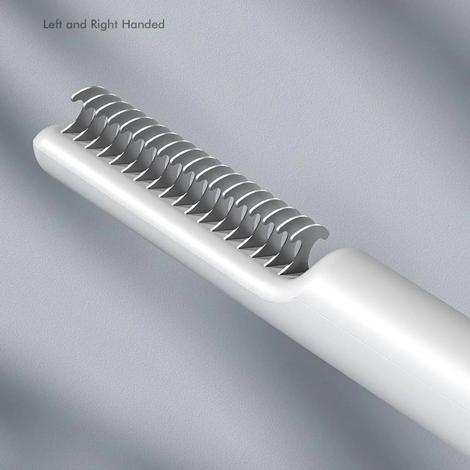 Stainless steel pet detangling comb with rake teeth on a pink handle for removing knots from dog hair.
