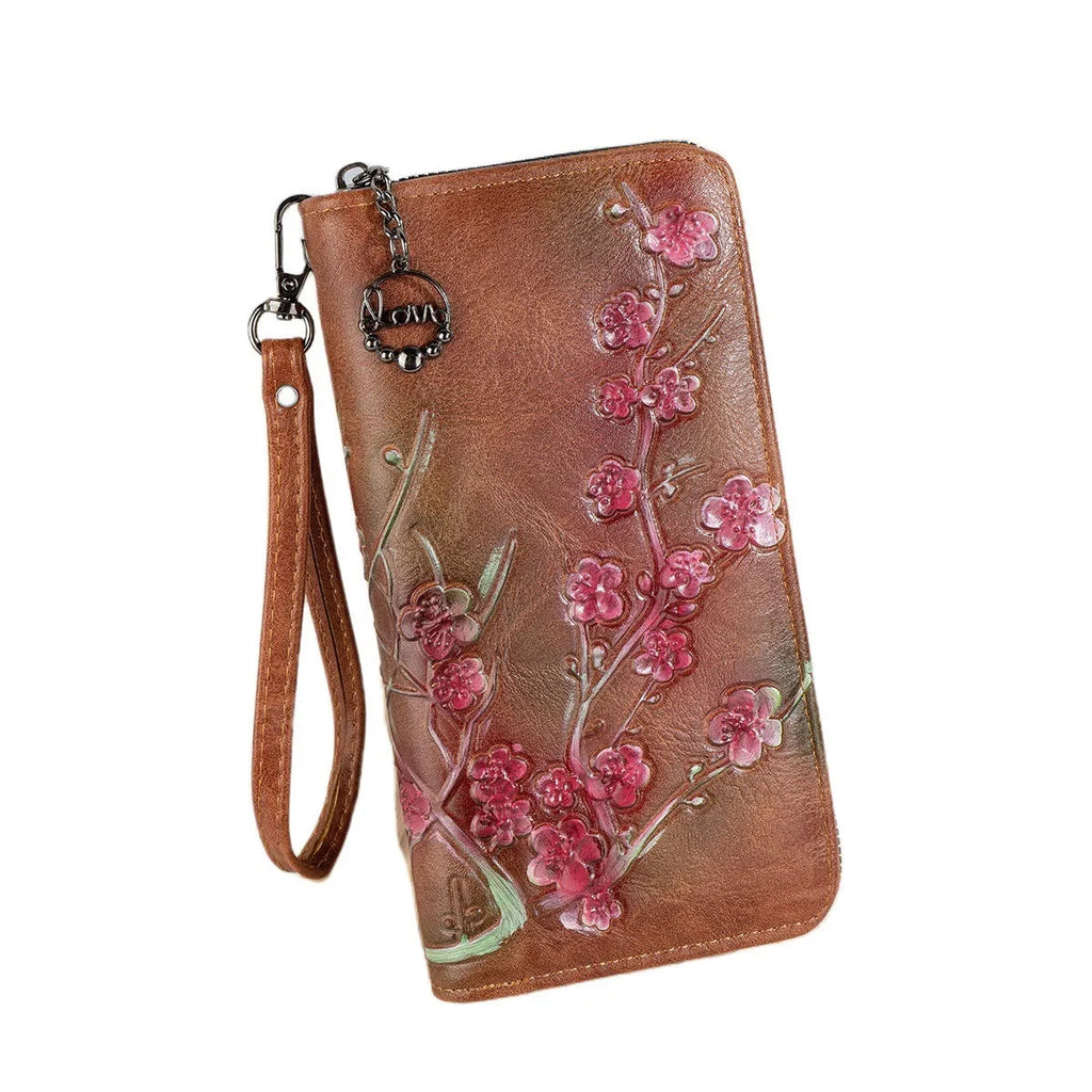 Embossed floral handbag with hand-painted details and a brass zipper in a retro style.