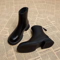 Women's black ankle boots with thick flat heel, round toe and back zipper closure