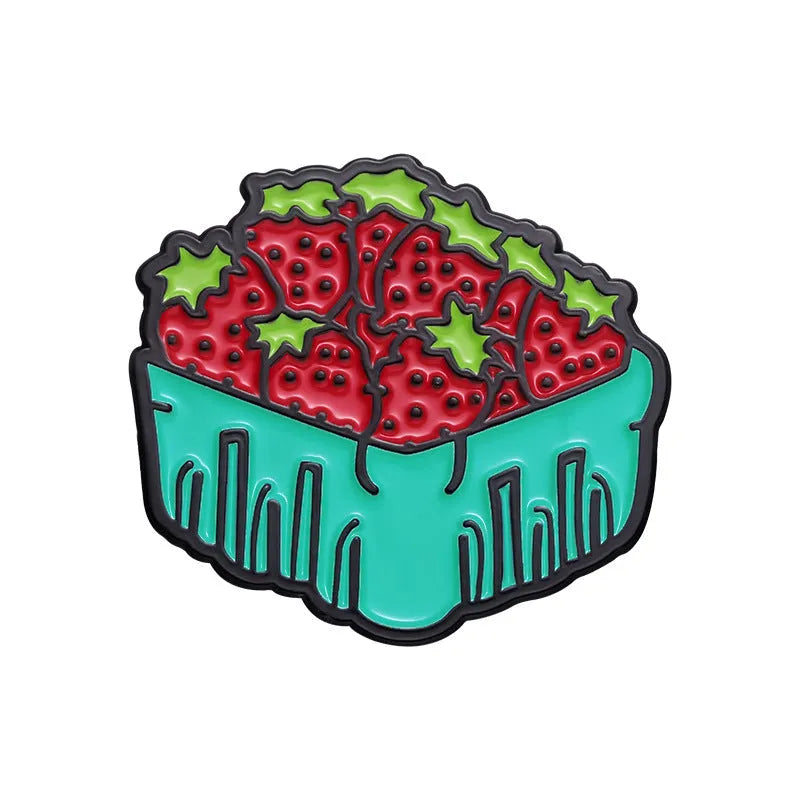 Colourful cartoon fruit design zinc alloy brooch pin on a fabric background.