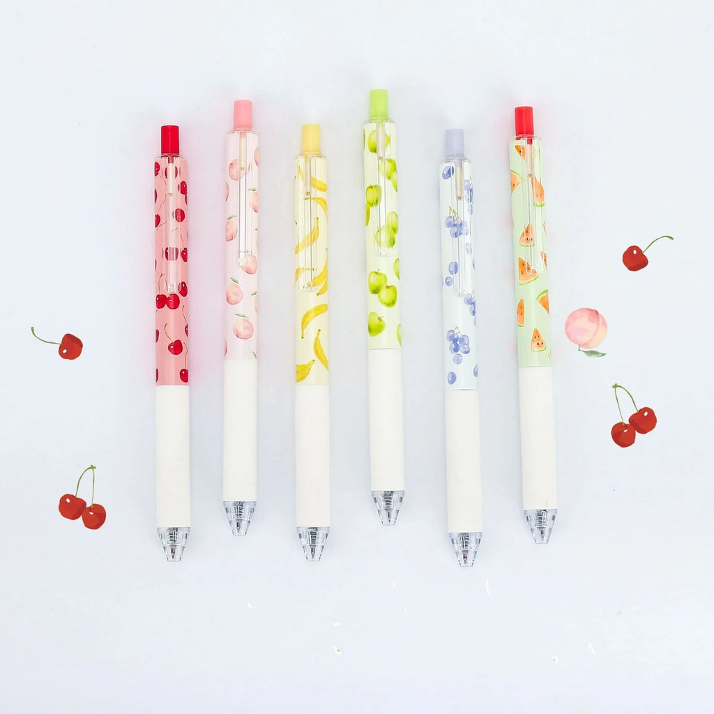 Three fruit scented press-action pens with 0.5mm quick-drying black refills on white background