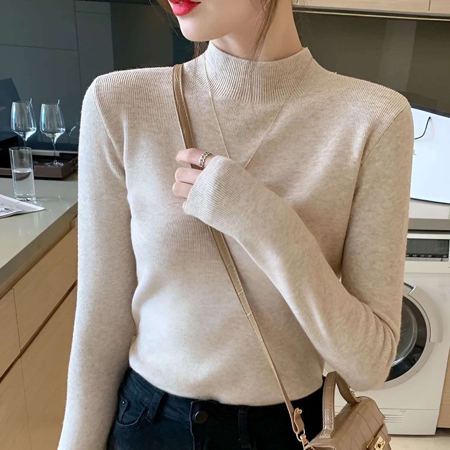 Women's slim fit viscose knitted long sleeve pullover top in apricot colour.