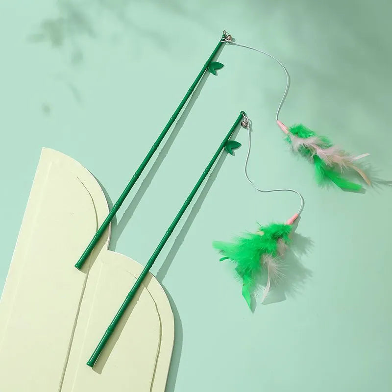 Green cat feather wand toy with bells and feathers on a durable wand with comfortable grip handle