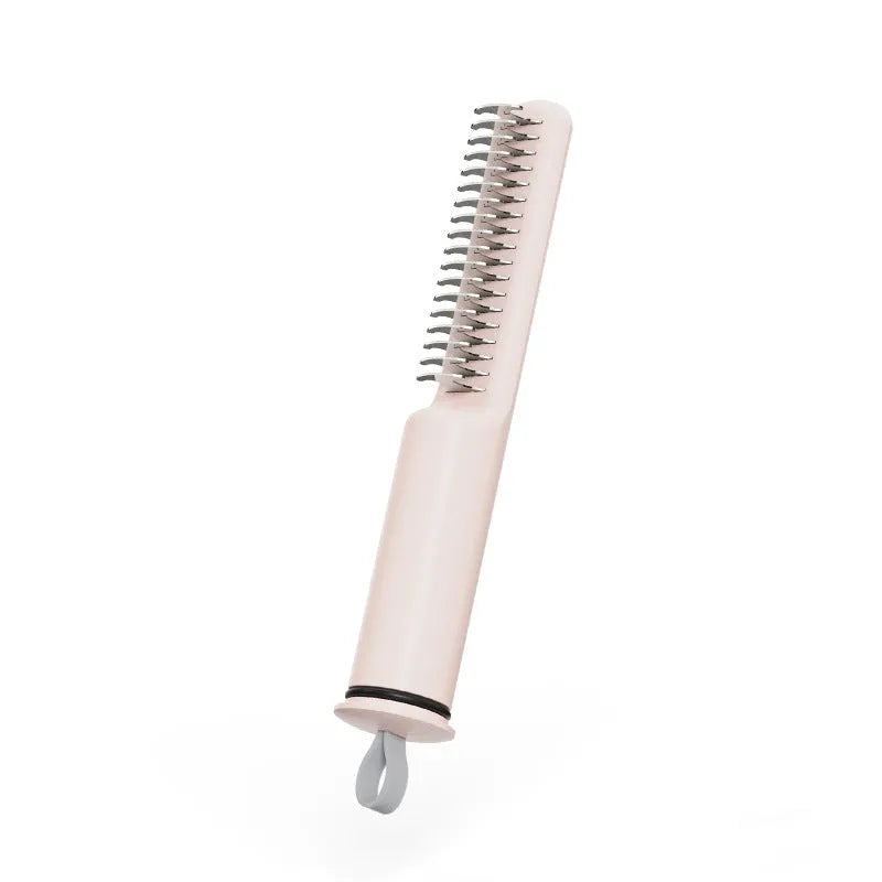 Stainless steel pet detangling comb with rake teeth on a pink handle for removing knots from dog hair.