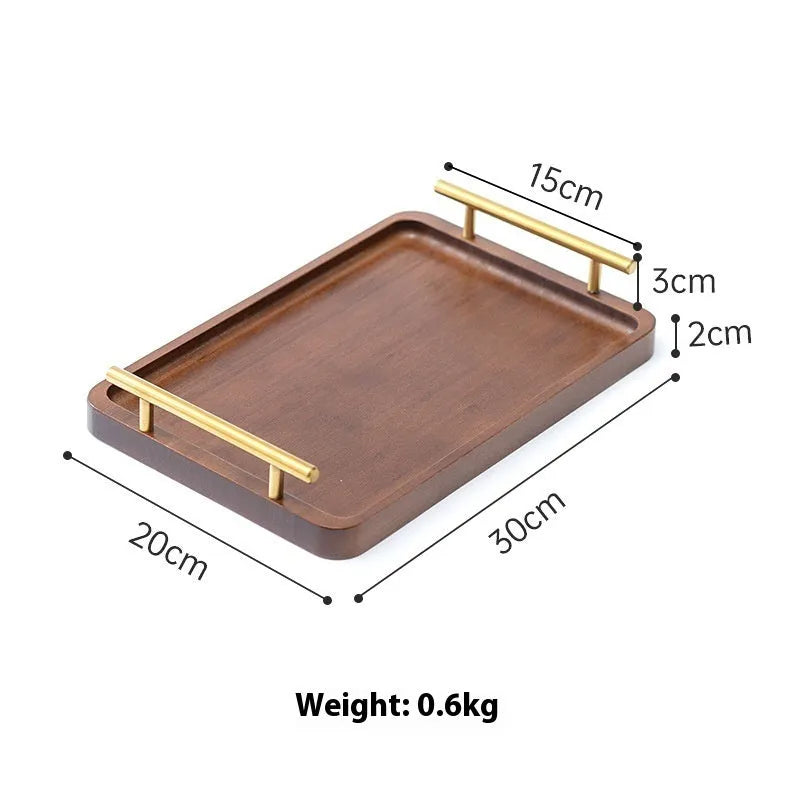 Square bamboo serving tray with brown handle on solid colour surface