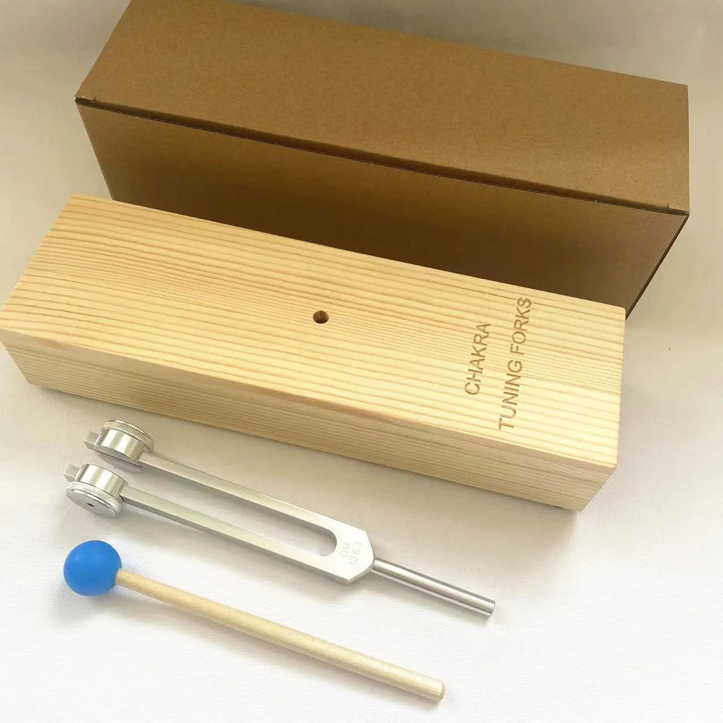 Aluminium alloy 432Hz tuning fork with connected speaker on kraft paper box