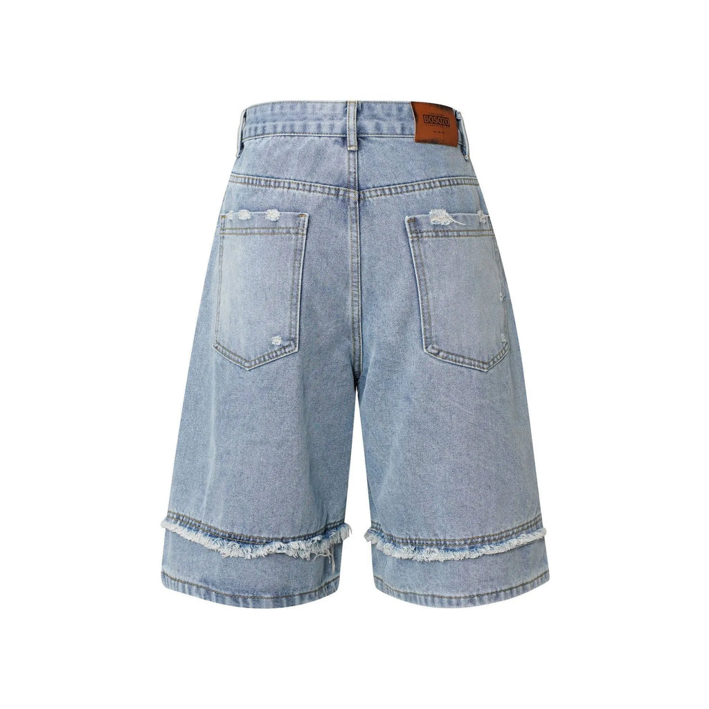 Distressed raw edge denim shorts in a straight leg cropped cut, shown in light blue colour.