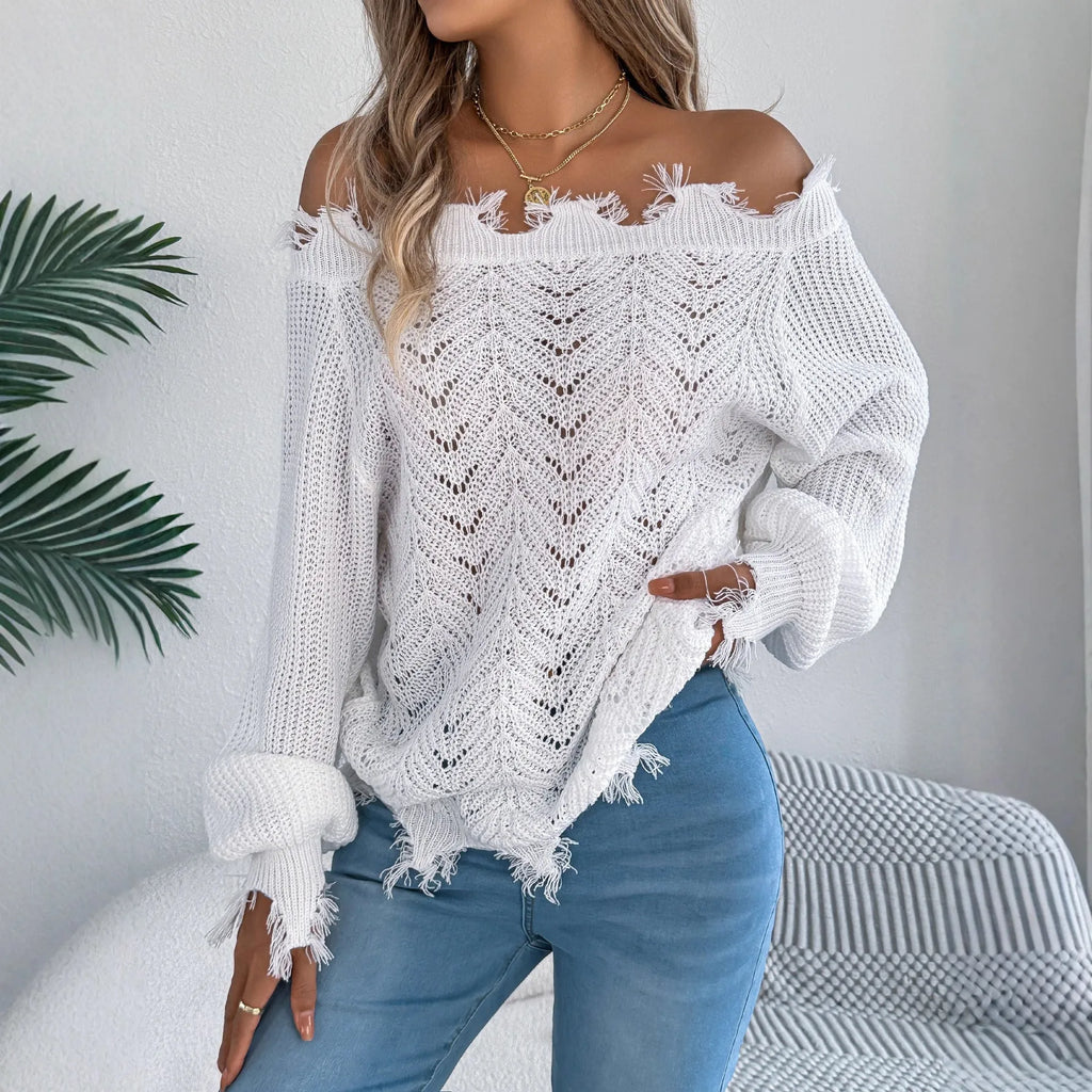 White hollow-out cut off-the-shoulder pullover sweater with long sleeves on a hanger.