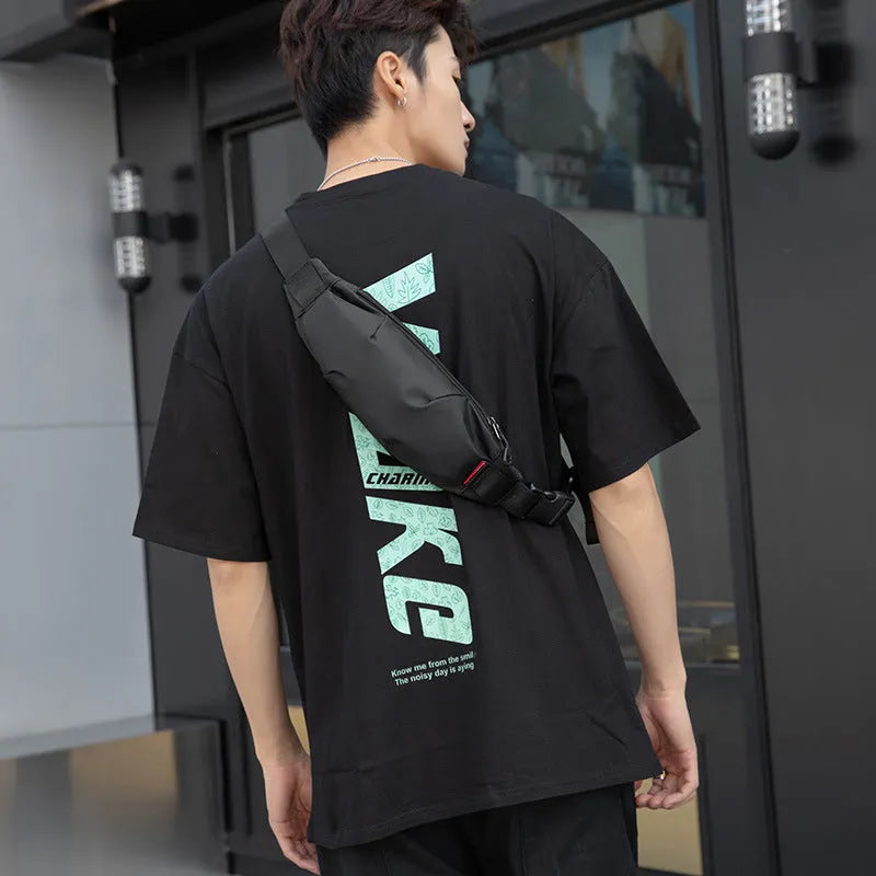 Black Oxford cloth men's waist pack with crossbody strap, shown with zipper open revealing phone and ID pockets.