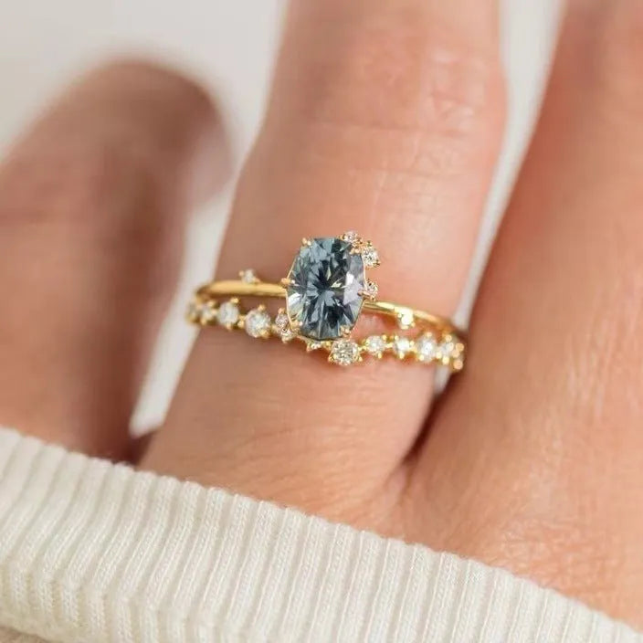 Gold-plated women's ring with flower shape and green zircon stone, shown as a pair.