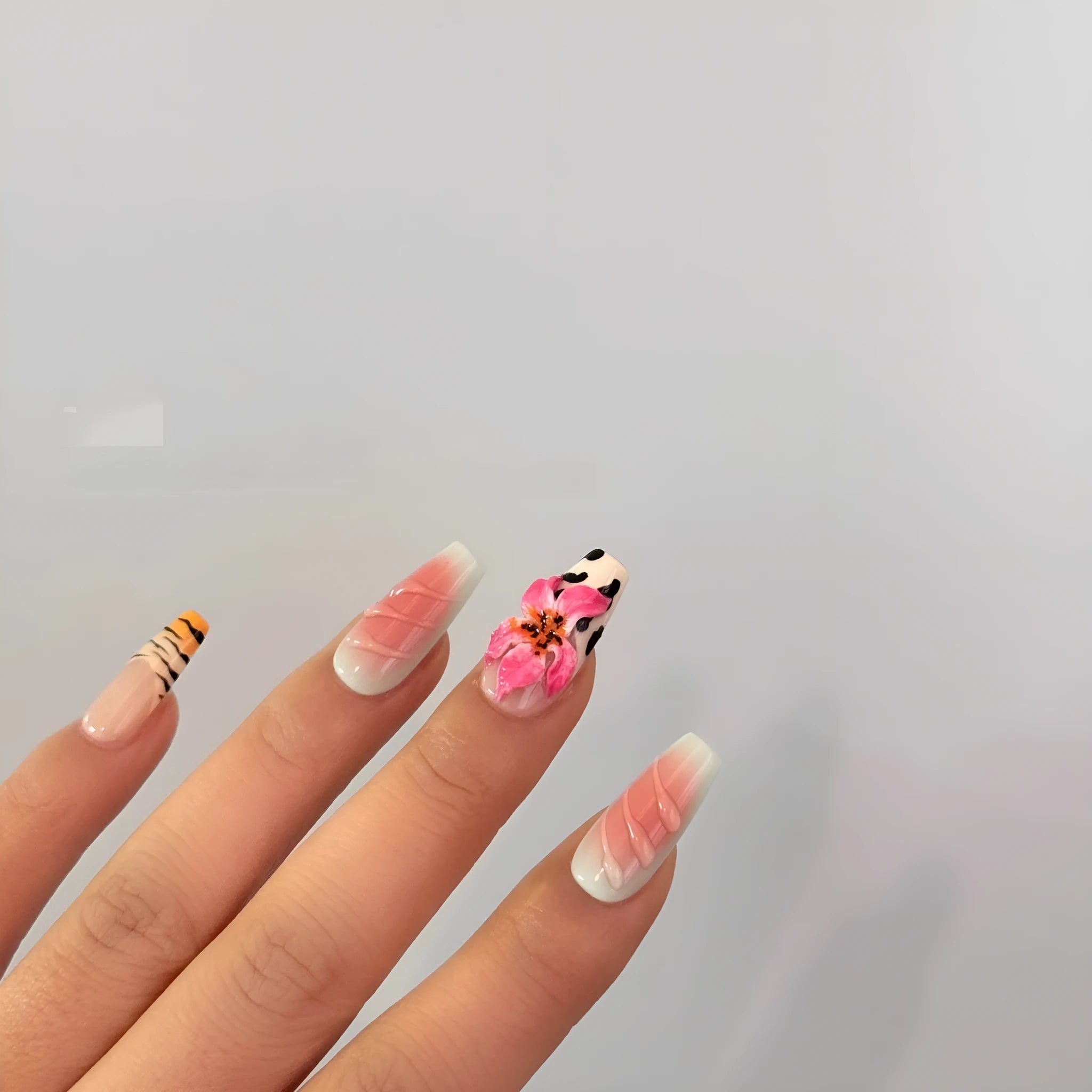 Hand carved false nails featuring a textured zebra pattern lily design in sizes XS, S, M, L.