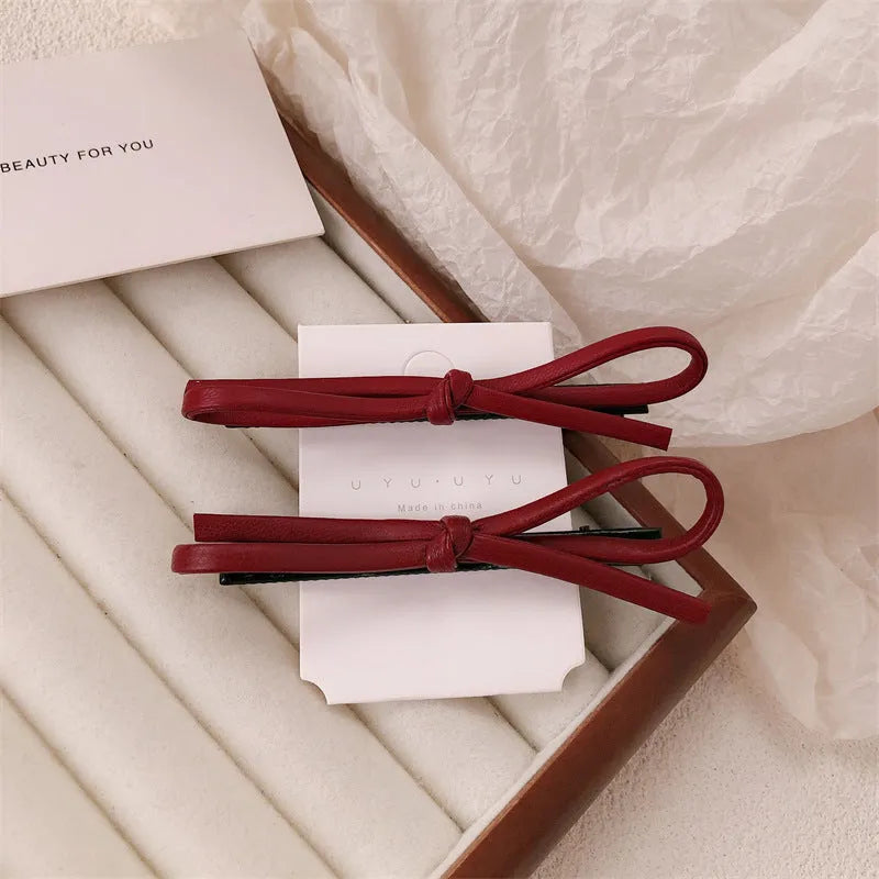 Wine red leather bow barrettes hair clips for women, available singly or in pairs