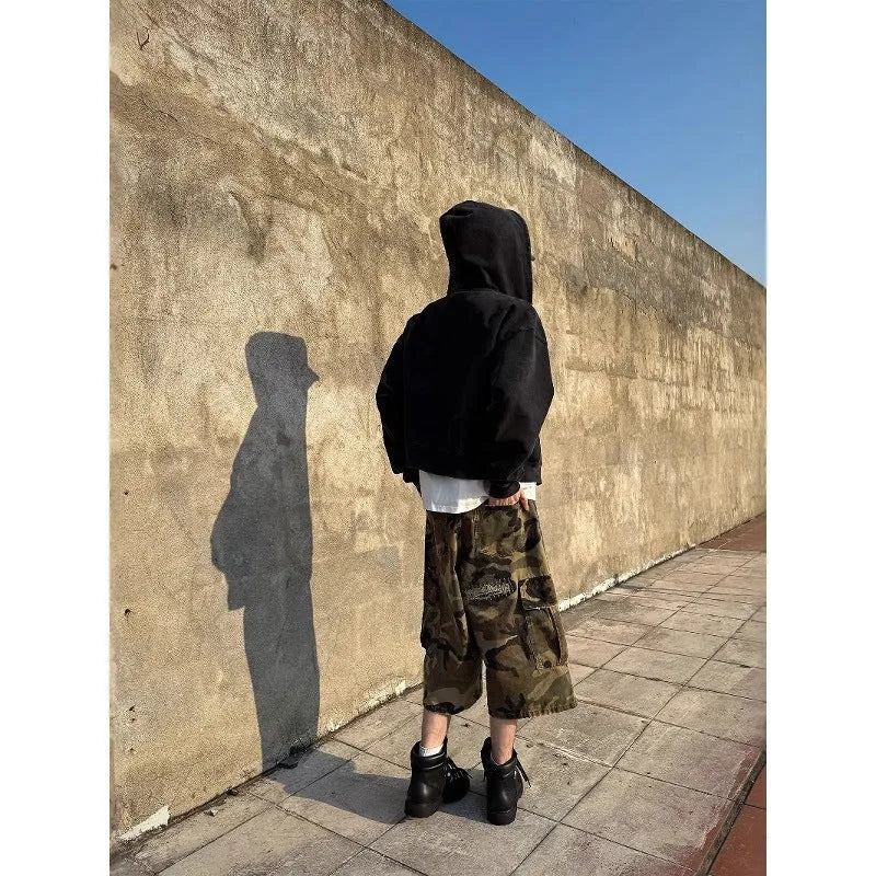 Men's loose-fit camouflage cropped jeans with ripped knee detailing, shown in a straight-leg silhouette.