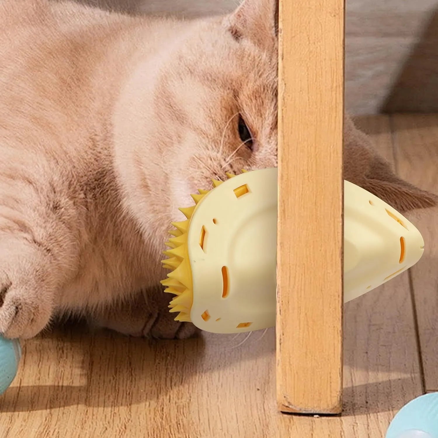 Yellow durian-shaped cat corner scratcher with massage comb mounted on wall corner