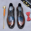 Coffee blue mens leather brogue boots with colour blocking and carved detail, shown from the side.