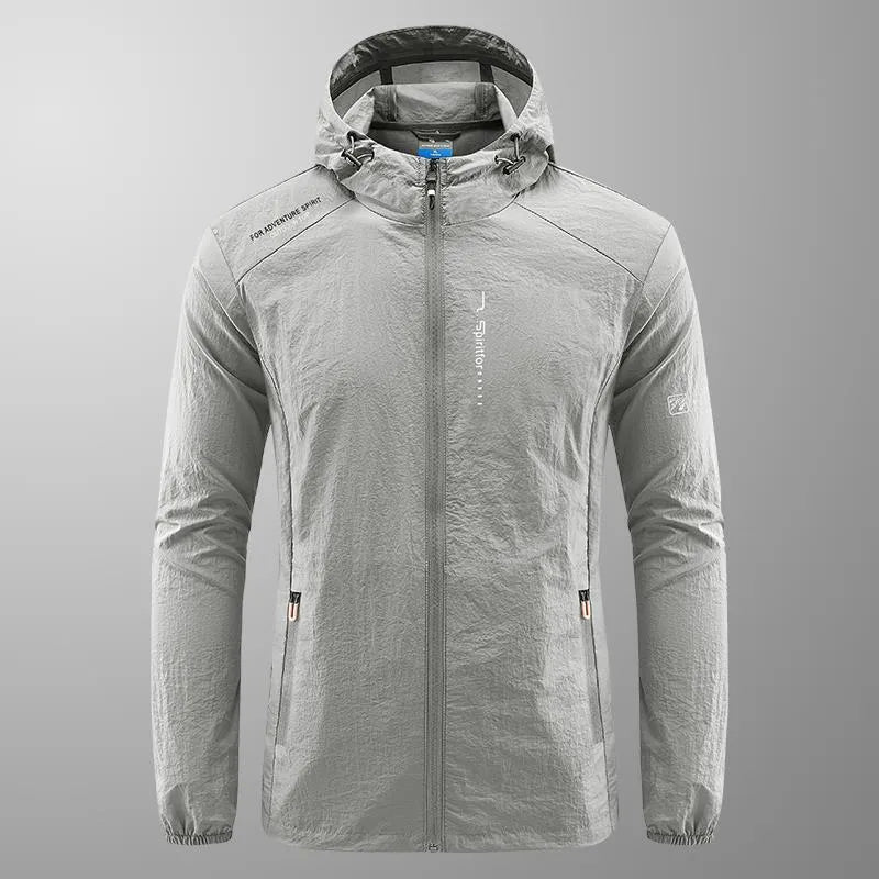 Man wearing a loose-fit light grey hooded nylon jacket for summer sun protection.