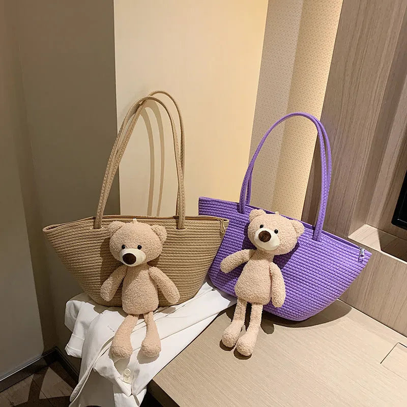 Woven cotton linen shoulder bag in dumpling shape with double straps and three-dimensional pocket.
