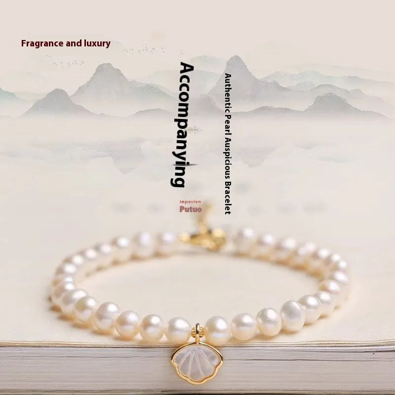 Close-up of a women's freshwater pearl bracelet with pearls arranged in a fan shape on a wrist.