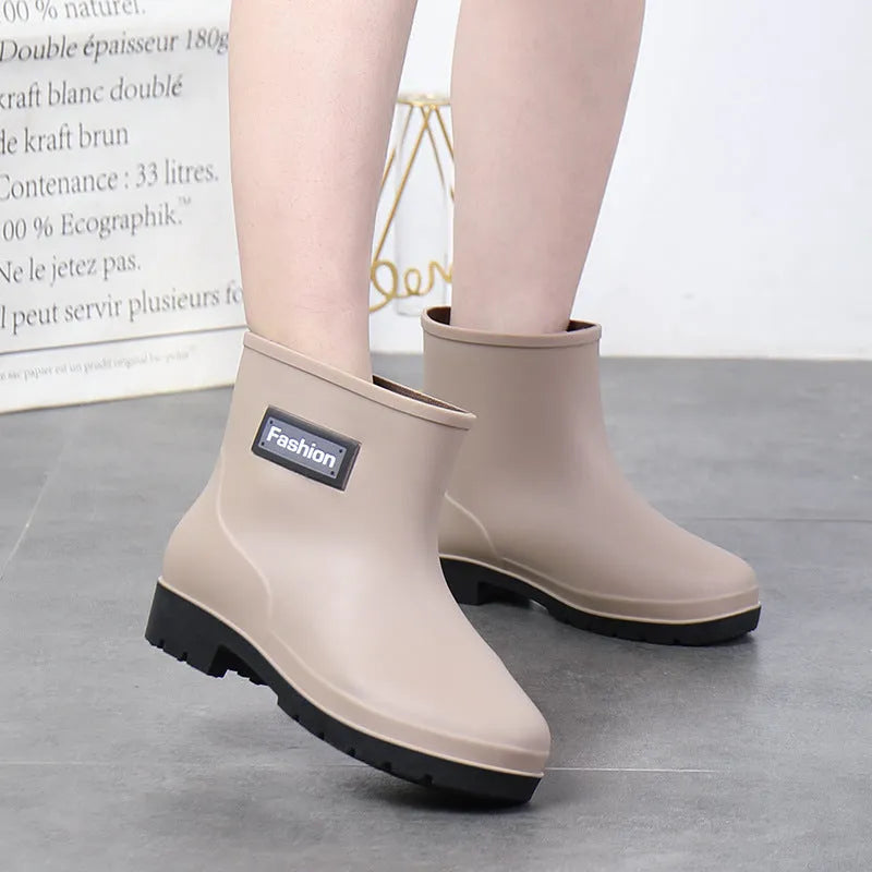 Women's mid-calf rain boot in PVC, low heel, shown in black colour.