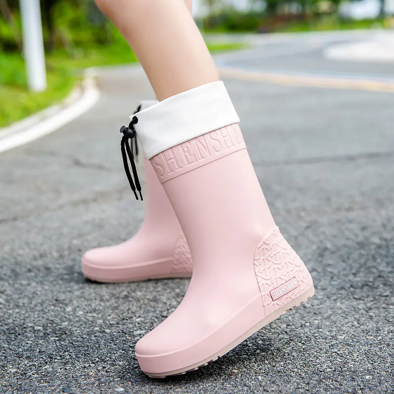 Women's solid colour PVC rain boots in apricot, shown with a non-slip sole.