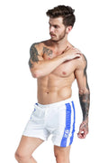 Men's blue lace-up sports shorts with slim fit and removable padding on athletic background