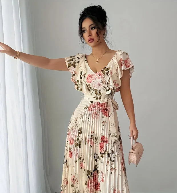 Apricot coloured floral print V-neck dress with ruffle sleeves and a flowing swing skirt.