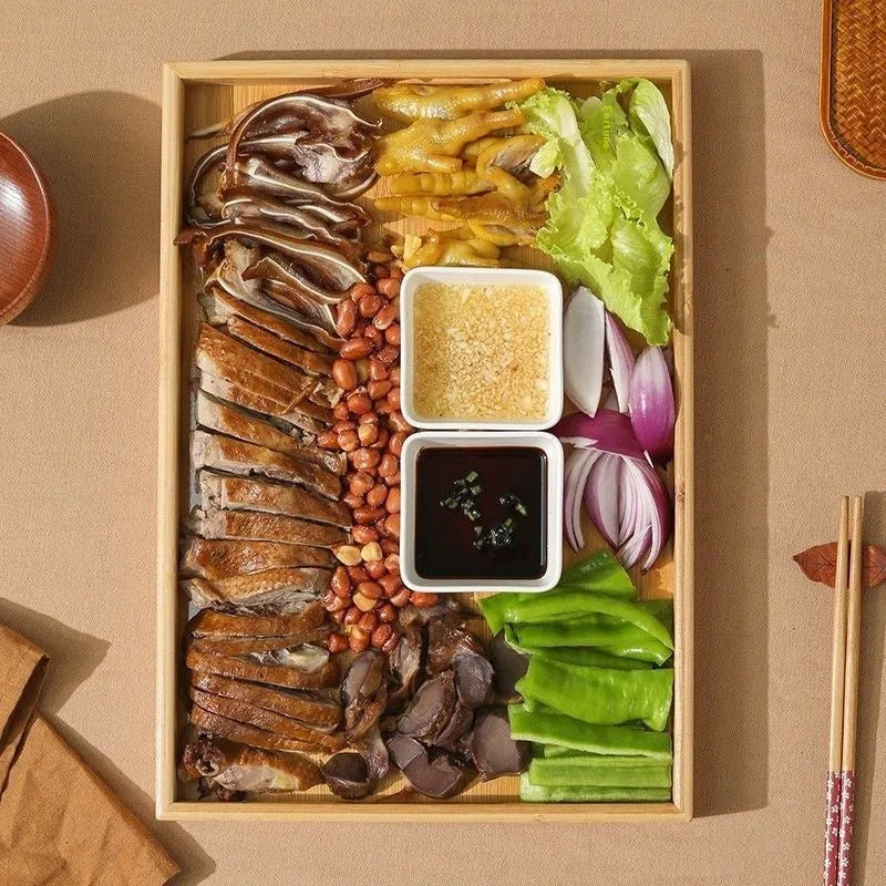 Square bamboo serving tray with brown handle on solid colour surface