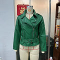 Black punk style leather jacket with a Peter Pan collar and regular sleeves on a hanger.