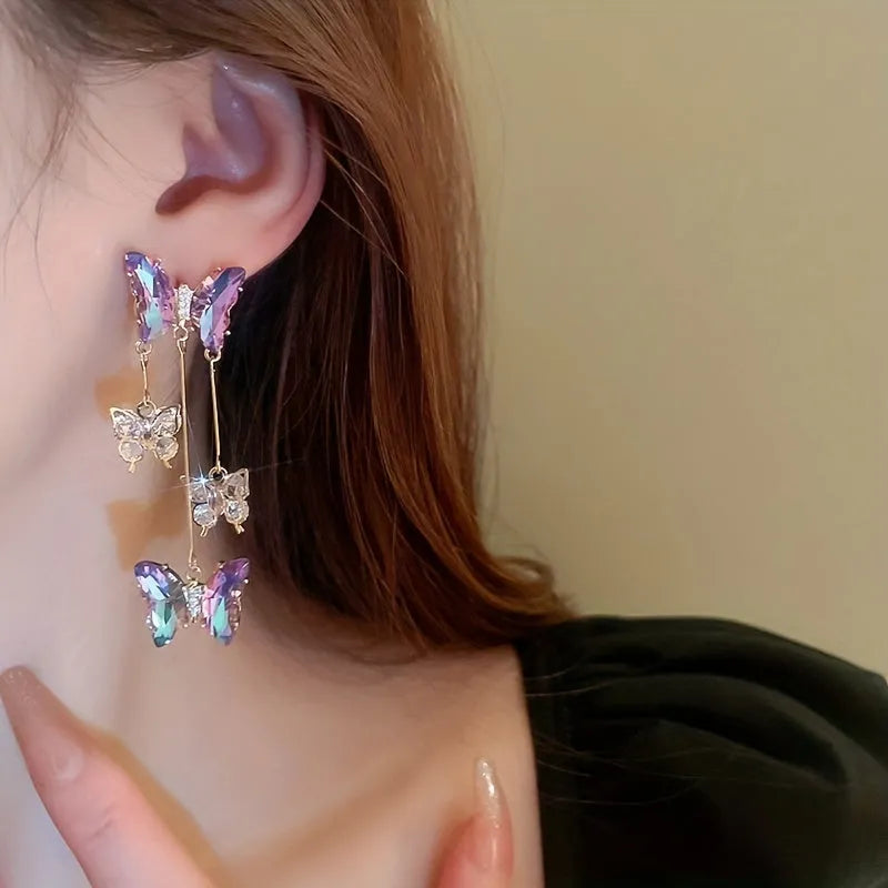 Blue purple butterfly earrings with silver needle crystal flowers and tassel detailing on alloy base