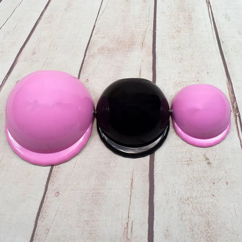 Plastic dog motorcycle cap helmet in various colours and sizes on a table