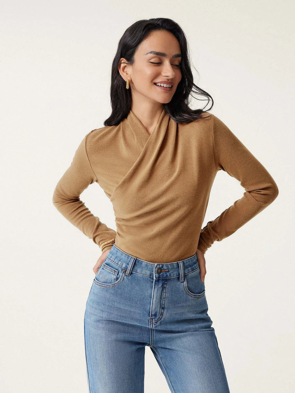 Camel-coloured women's slim fit pullover sweater with long sleeves on a hanger.