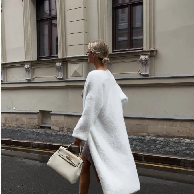 Women's long white knitted cardigan jacket with long sleeves shown open.