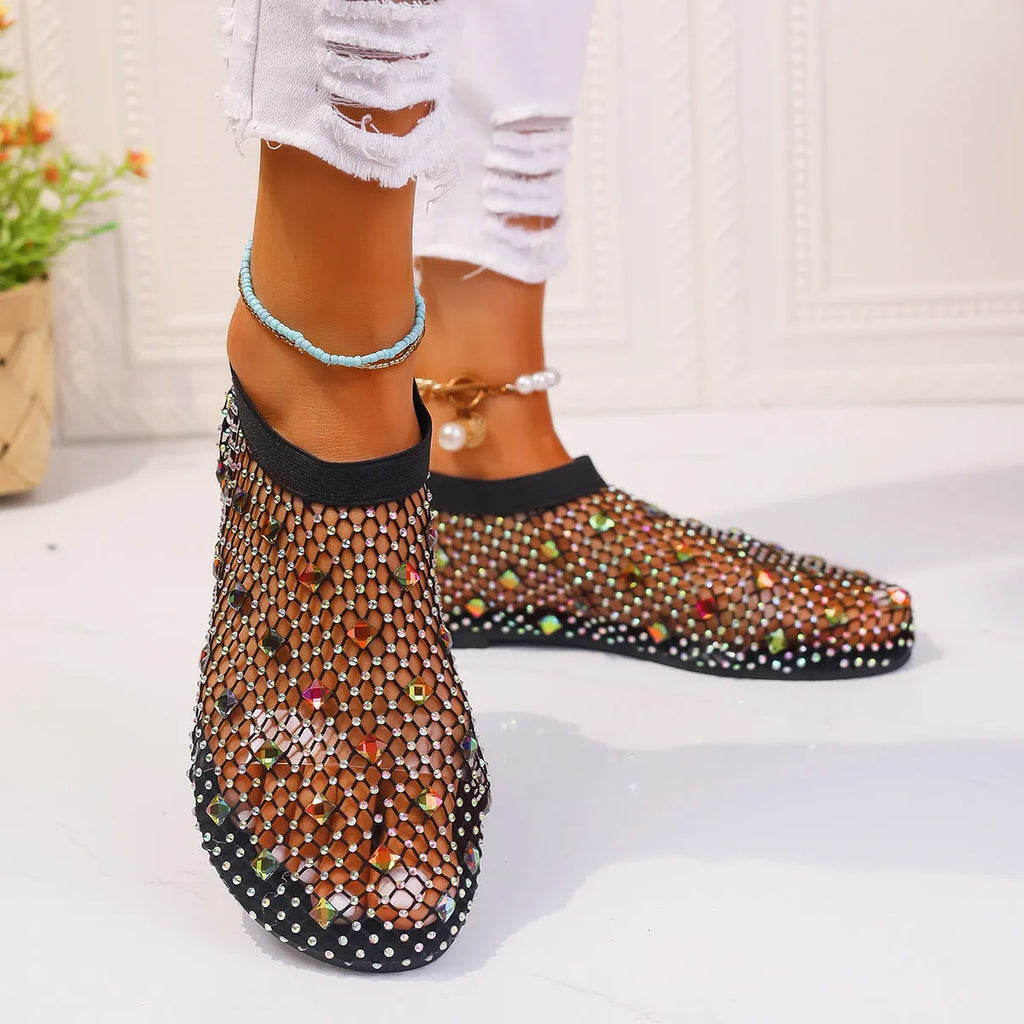 Women's flat mesh sandals with colourful rhinestone decoration on the upper and a round toe.