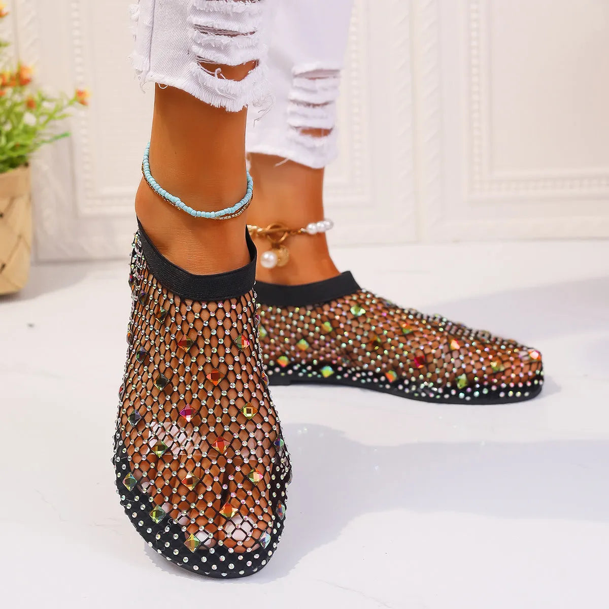 Women's flat mesh sandals with colourful rhinestone decoration on the upper and a round toe.