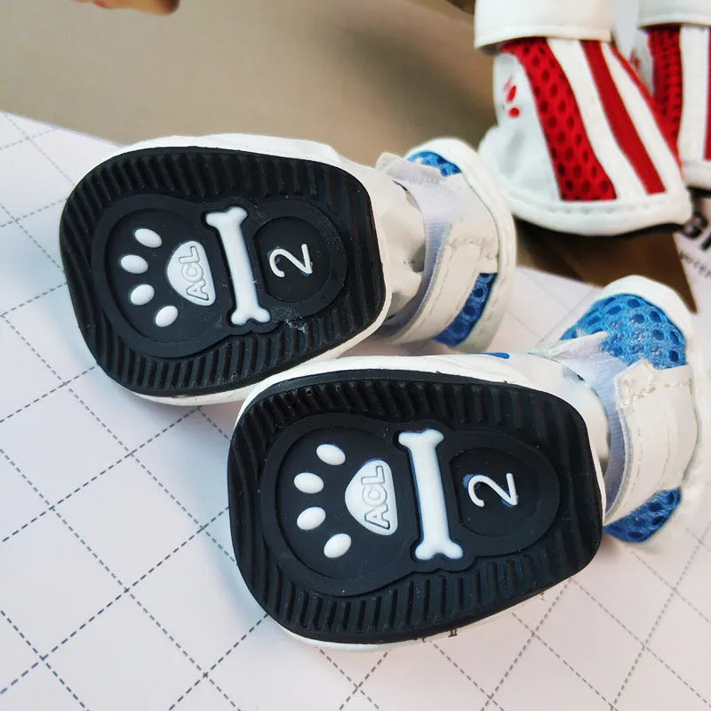 Set of four blue cloth dog shoes with zip closure and non-slip soles for pets.
