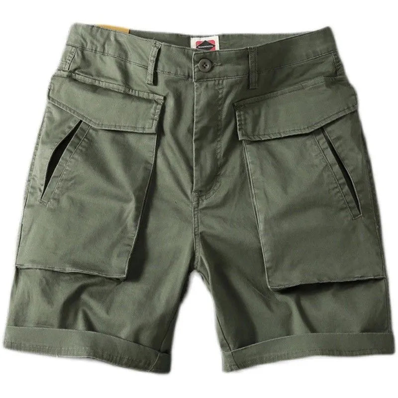 Men's straight-leg cotton cargo shorts in khaki with multiple pockets, shown on a model.