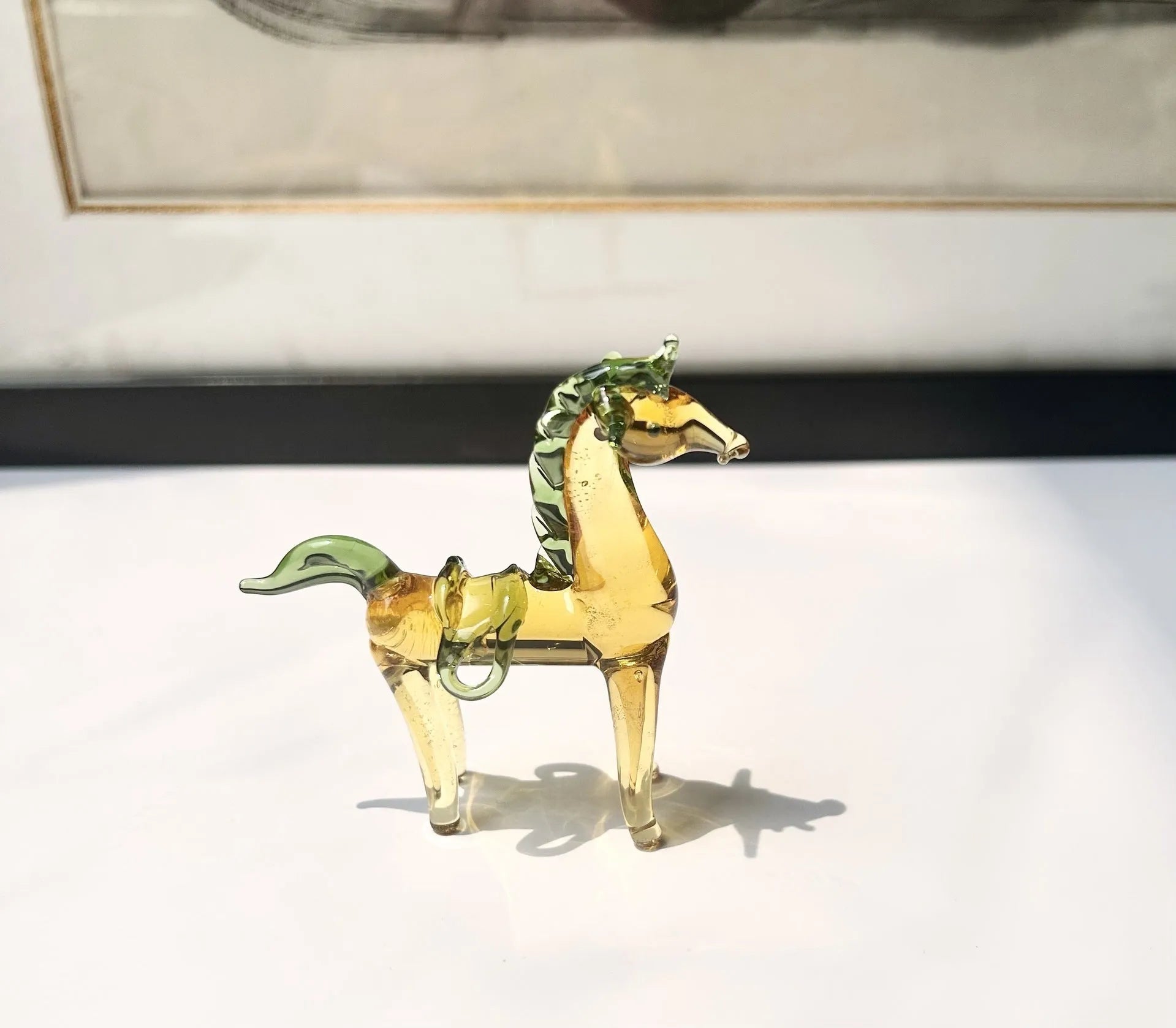 Glazed ceramic horse figurine decoration in modern simplicity style on a desk.