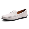 Men's suede leather Gommino loafers in black on a flat rubber sole, showing round toe and sewing line detail.