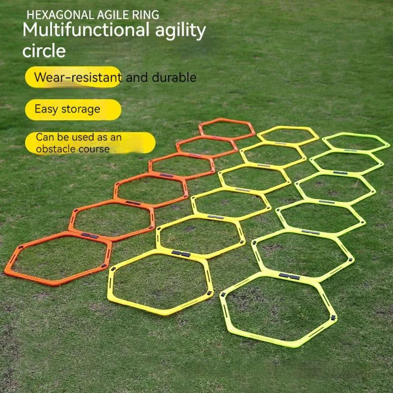 Set of six foldable yellow green and orange hexagon football agility training rings on grass