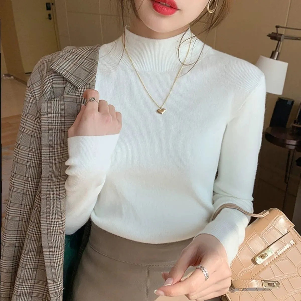 Women's slim fit viscose knitted long sleeve pullover top in apricot colour.