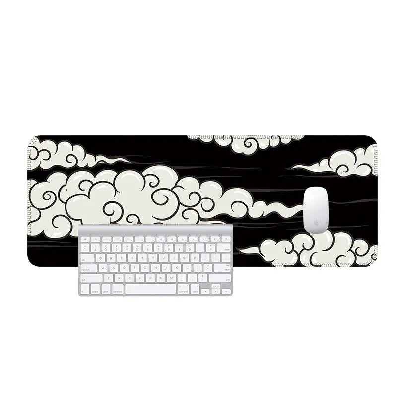 Large cloud pattern mouse pad with non-slip rubber base on a desk