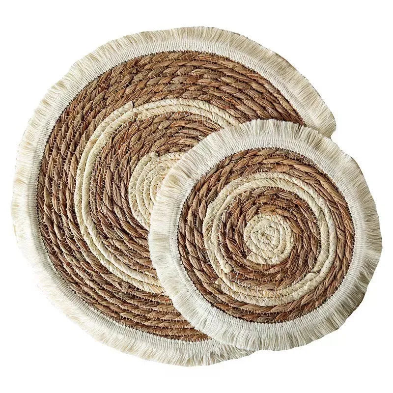 Round Japanese straw placemat with corn rope tassels in natural papyrus colour on wooden table