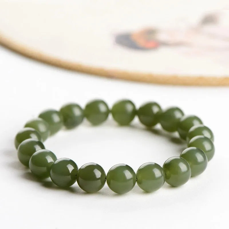 Hetian jade ball bracelet with spherical polished beads in clear colour tones