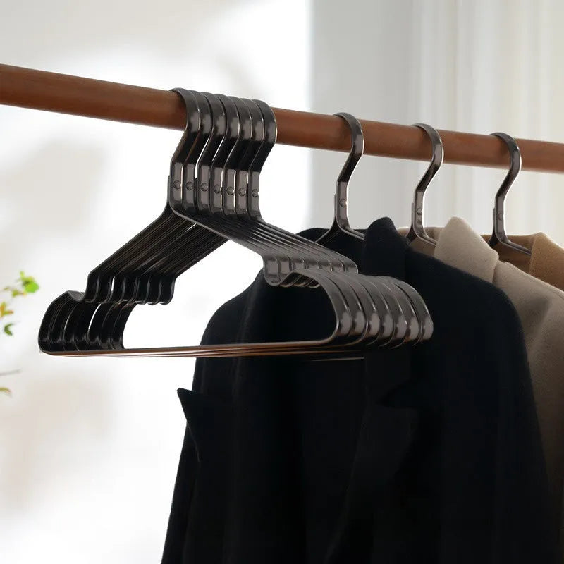Elegant black modern clothes hanger with non-slip shoulders on a white background.