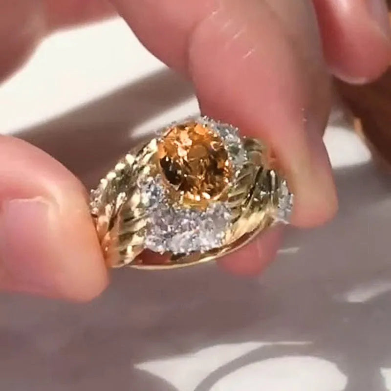 Gold-tone copper women's ring with embossed feather design and inlaid yellow zircon stones.