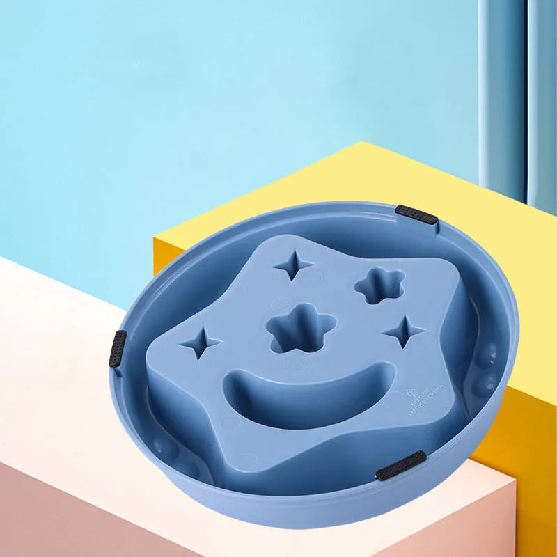 Blue slow feeder dog bowl with moon and star wing design and internal maze pattern.