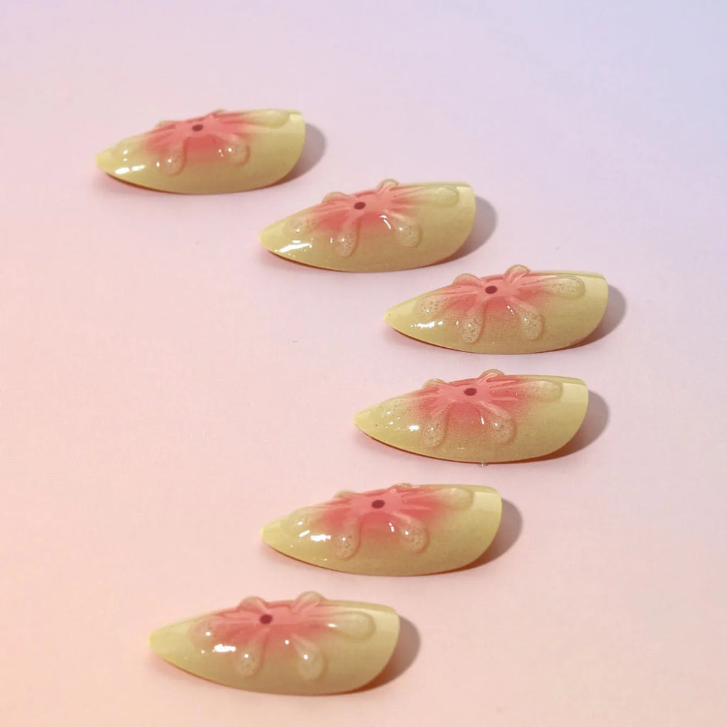 Simple fake nails with raised 3D cartoon flower design in TY-318 colour, shown with jelly glue tube and filing strip.