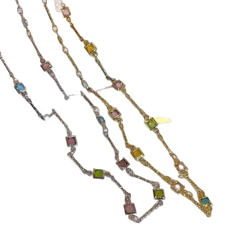 Fine geometric clavicle chain necklace with square artificial crystal links in gold or white K plating.