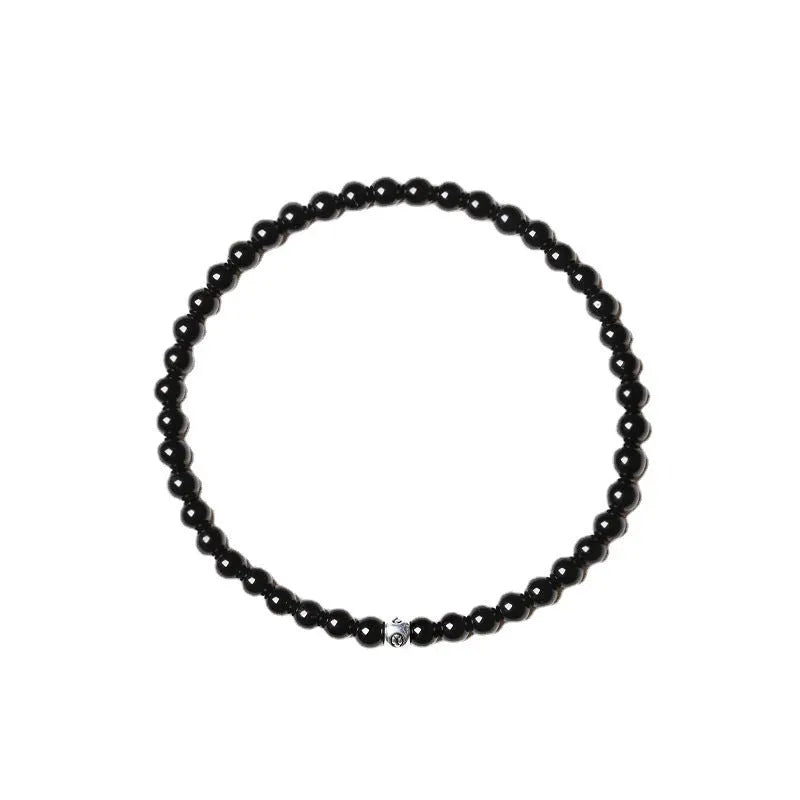 A unisex geometric bracelet with round and square obsidian, blue San and agate beads on a black background.