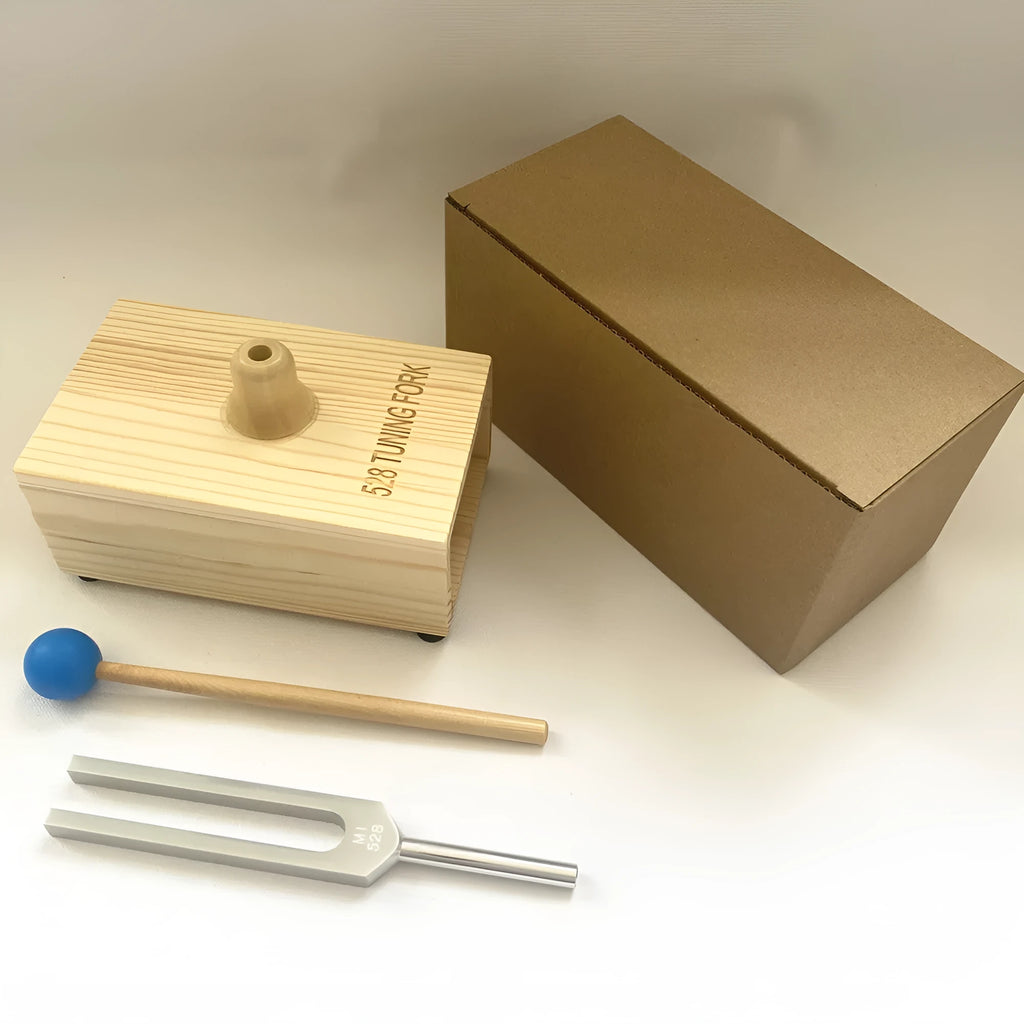 Aluminium alloy 432Hz tuning fork with connected speaker on kraft paper box